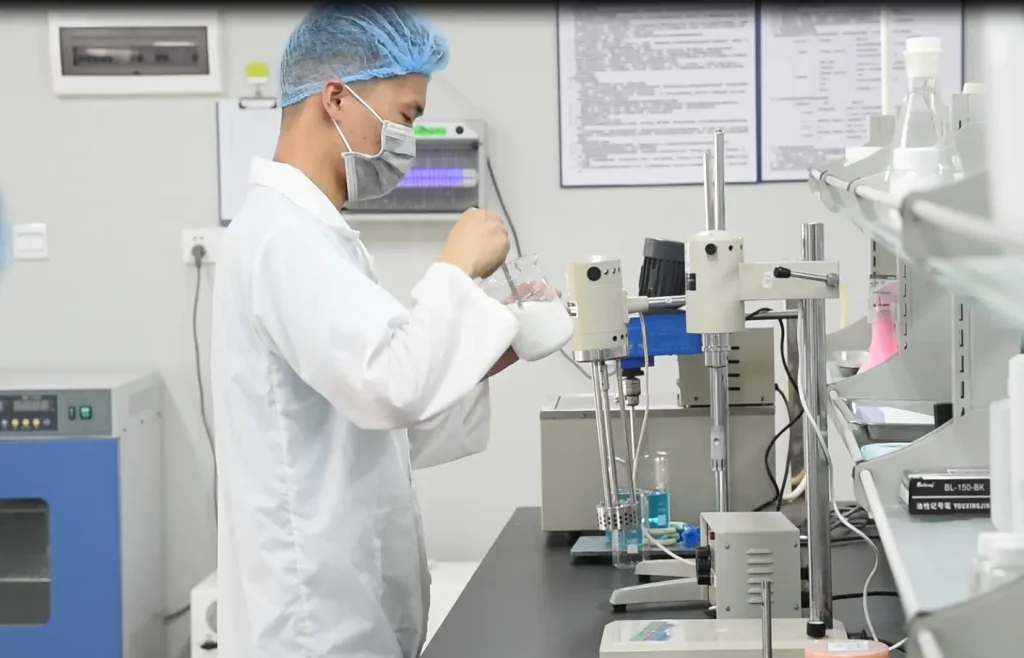 R&D technician performing physical stability tests to ensure long-term formula integrity for custom hair care.