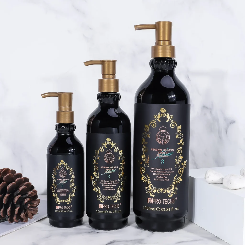 Three black bottles of "Renewal Keratin Smooth Shampoo 3" in 250ml, 500ml, and 1000ml sizes with gold pump dispensers and ornate labels, arranged by height on a marble surface next to a pinecone and white stones.