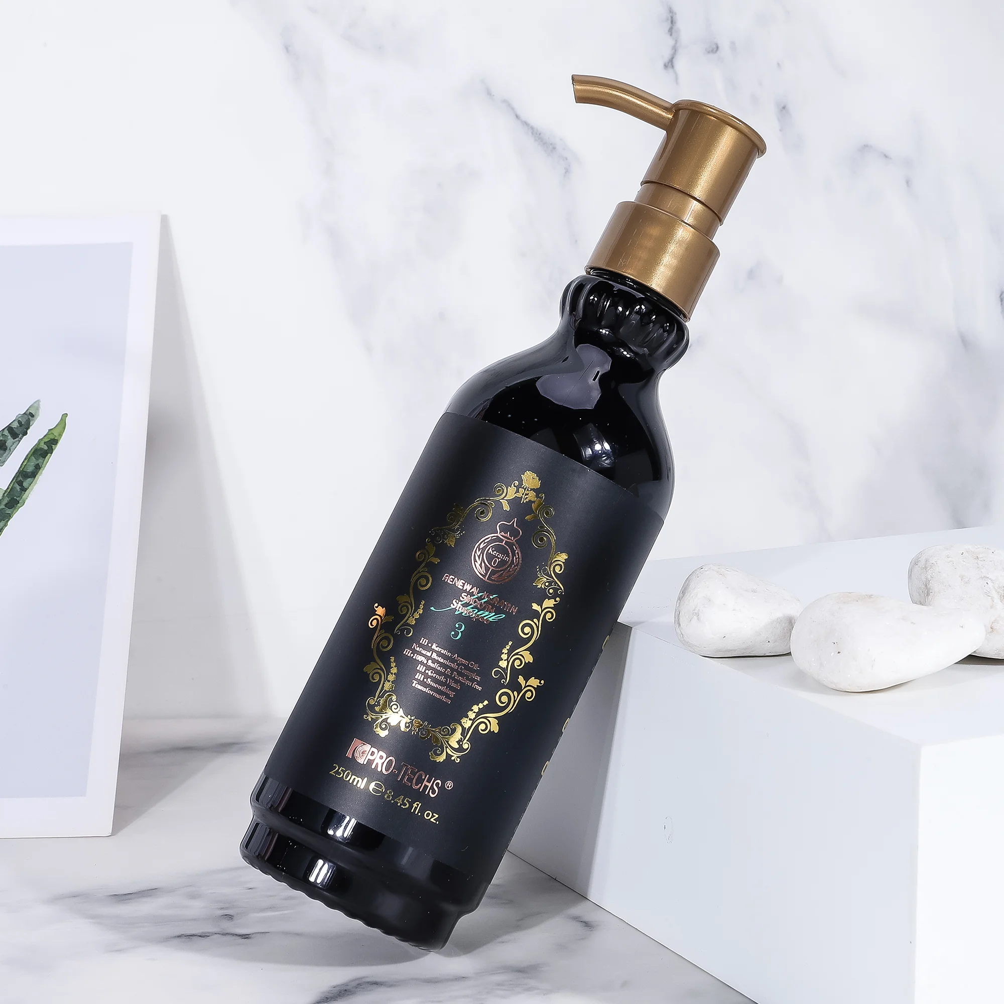 A sleek black 250ml bottle of "Renewal Keratin Smooth Shampoo 3" with an ornate gold label and gold pump dispenser, leaning against a white block on a marble surface with white decorative stones.