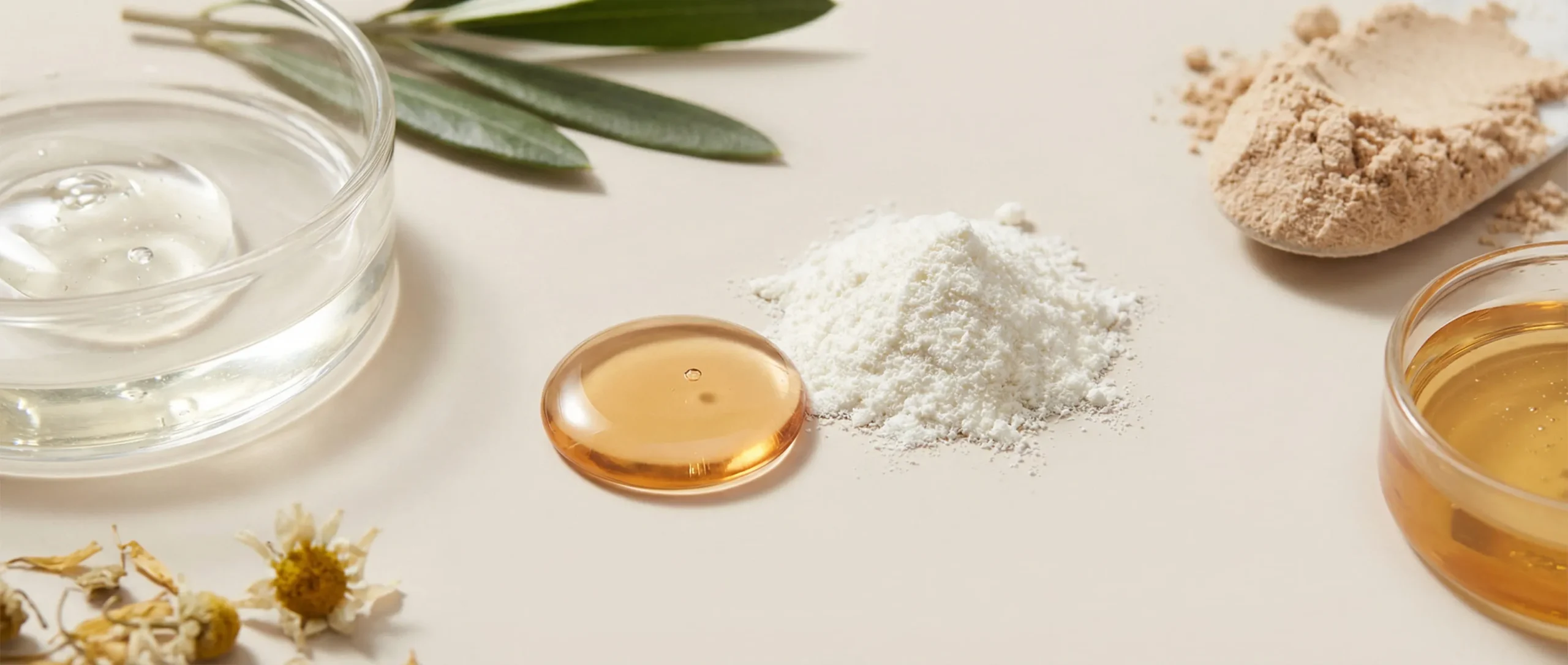 Macro shot of hair care raw materials: clear gel, white protein powder, and golden botanical oil droplets.