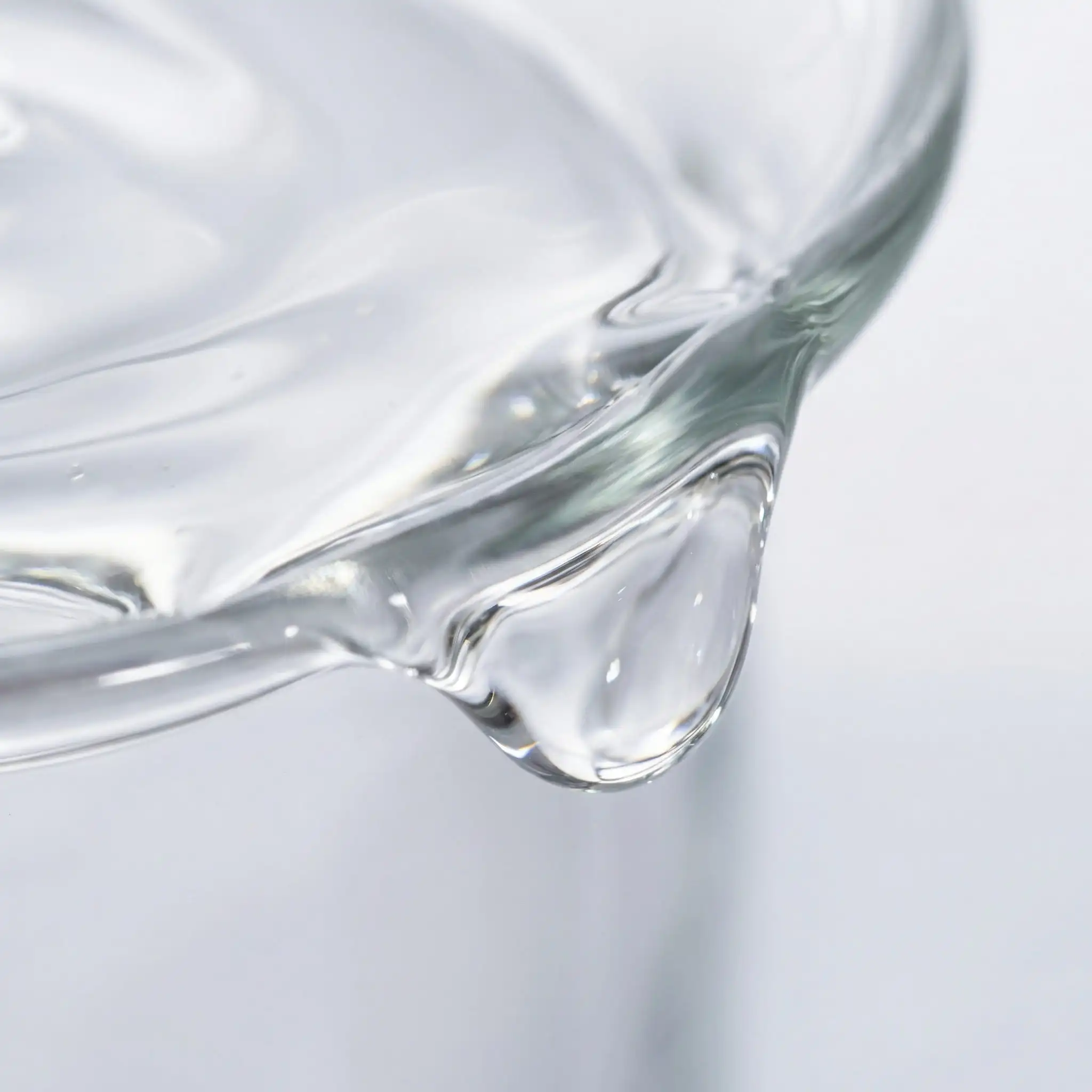Macro shot of clear, viscous Panthenol (Pro-Vitamin B5) liquid, a key ingredient for hair moisture and scalp repair.
