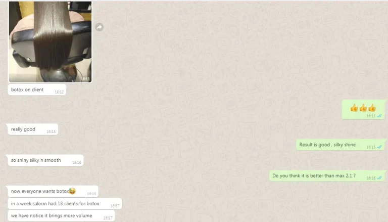 Close-up of a client’s long, sleek brown hair laid over a salon chair during a treatment.