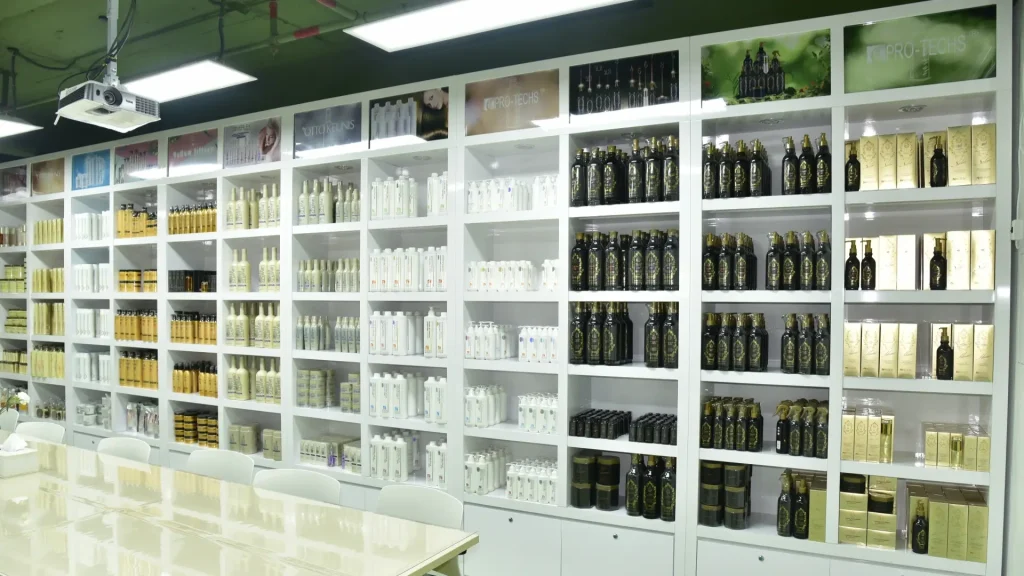 White display shelves stocked with an array of hair care products in a bright showroom.