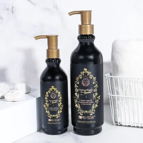 Two black pump bottles of Clarifying Shampoo No.1 (250ml and 500ml) with ornate gold labels, displayed on a marble surface next to white stones and a towel basket.