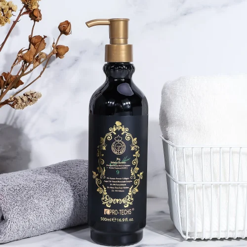 A 500ml black bottle of "Keratin Bio Instant 9" hair treatment with an ornate gold label and pump, styled on a marble surface next to a white wire basket with towels and a grey cloth.
